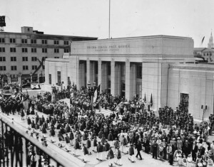 View showing the 1937 grand opening of the Hollywood Post Office (Hollywood Station) at 1615 Wilcox Avenue with a parade out front.