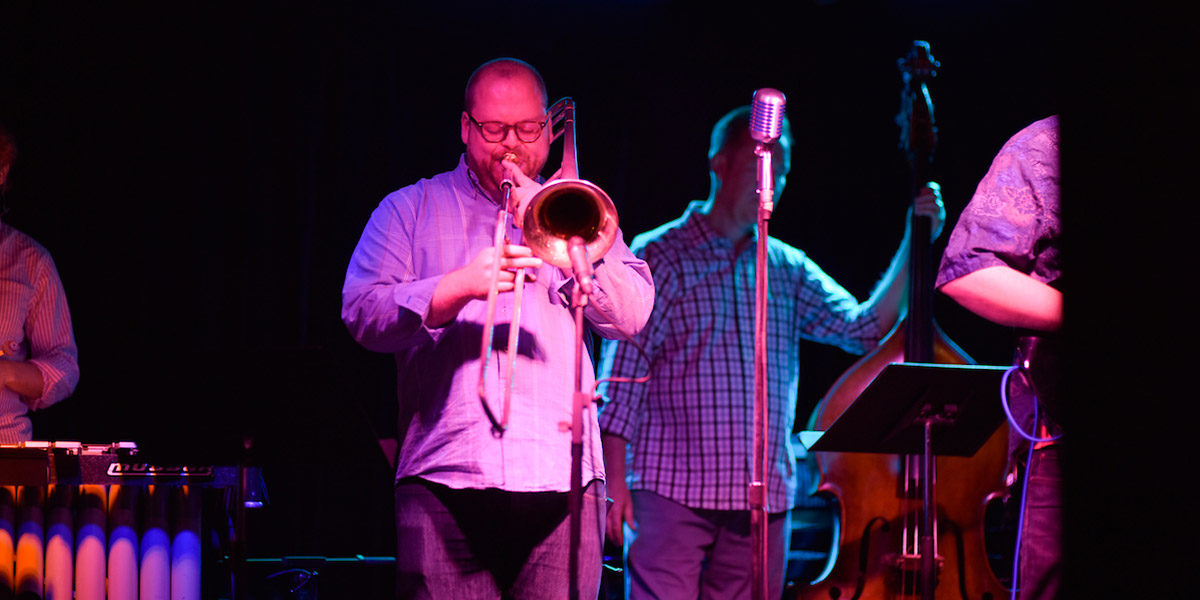 An image of a man playing the trombone on stage at BLU Jazz+ in downtown Akron.