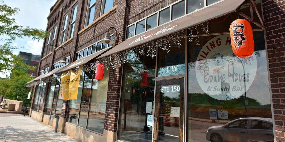 An image of the storefront of downtown Akron's restaurant The Boiling House on a sunny day.