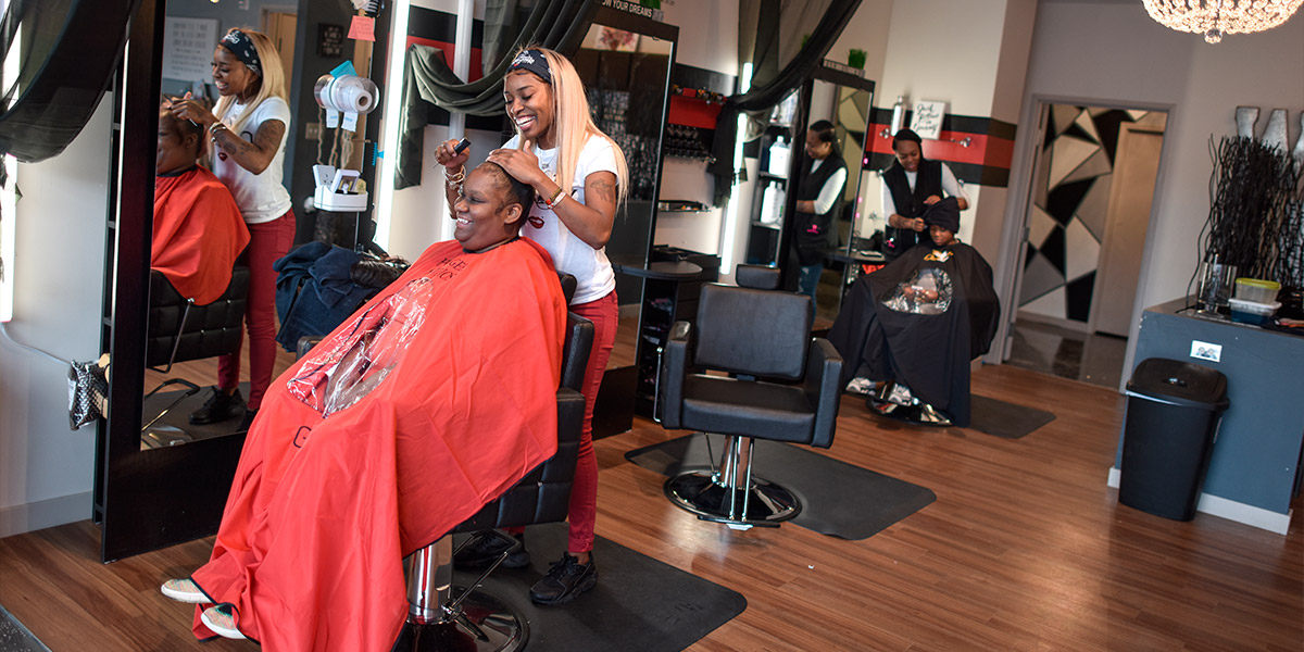Owner of Hair Geek Studio, Sapreea English, doing a customer's hair in her salon.